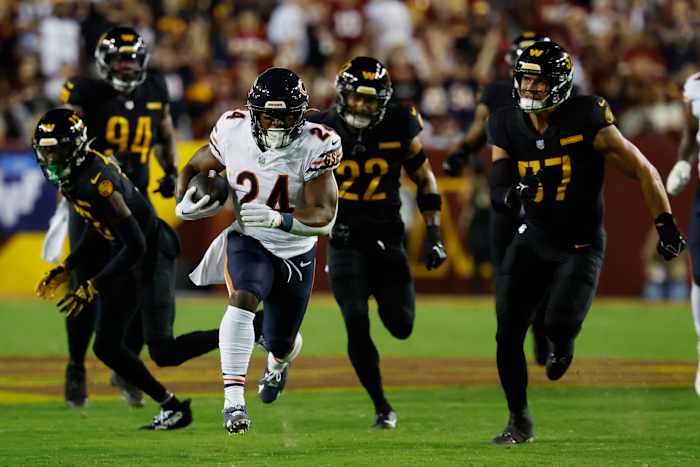 Chicago Bears running back Khalil Herbert (24) carries the ball as Washington Commanders linebacker Cody Barton (57) chases during the first quarter at FedExField.